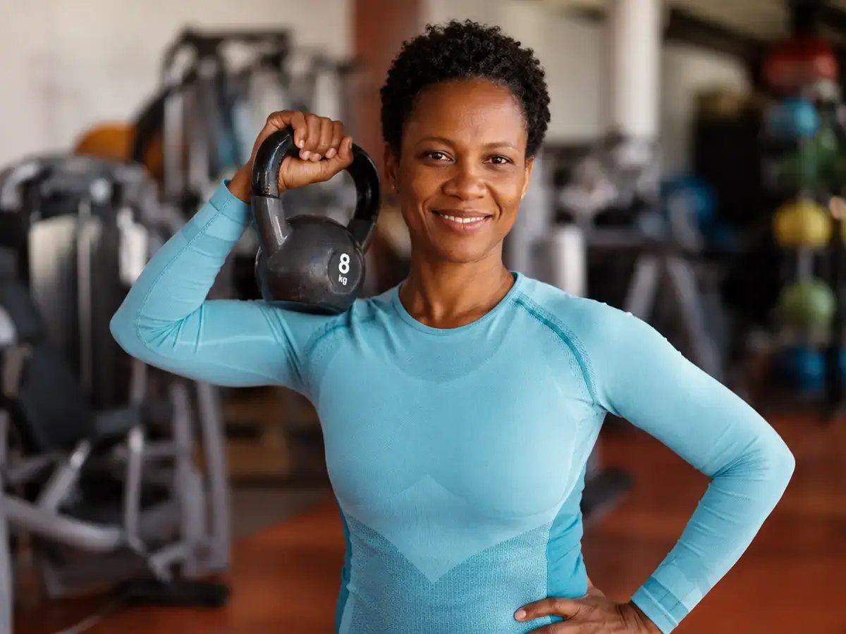 Strong Bones Woman holding a weight at the gym.